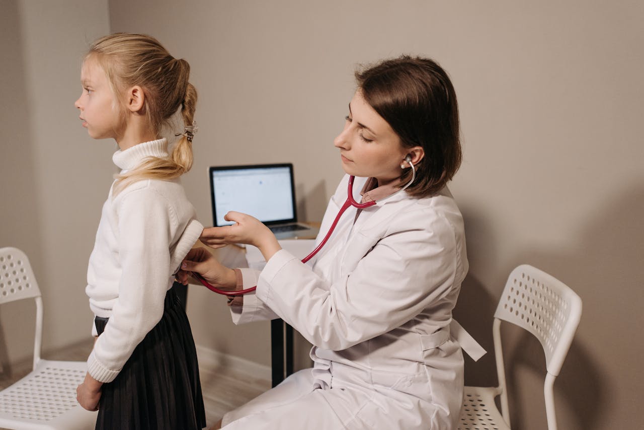 A Doctor Examining a Child Patient